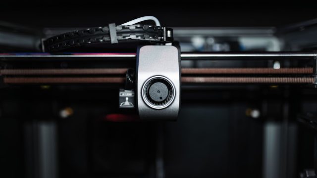 Macro shot of a 3D printer nozzle highlighting technology and precision