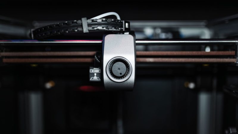 Macro shot of a 3D printer nozzle highlighting technology and precision